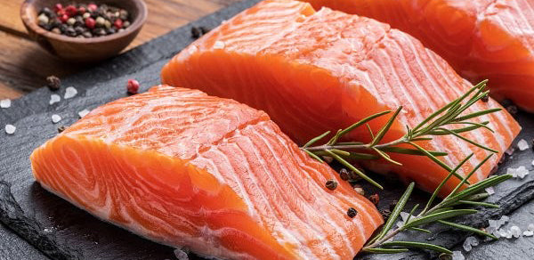 Fresh Salmon pieces on slate board